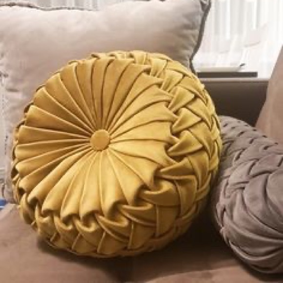 round yellow throw pillow